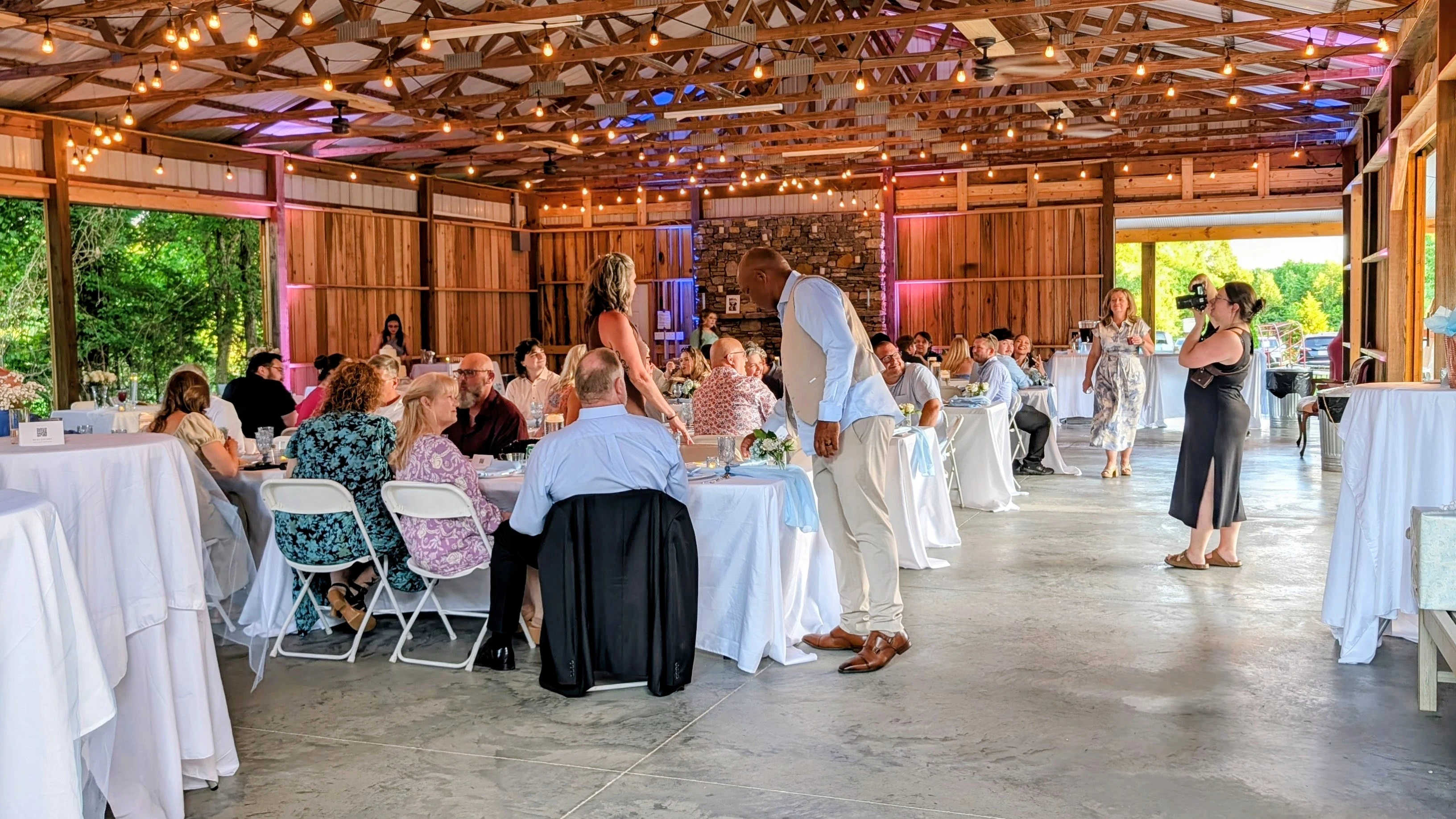 Barn wedding reception under string lights