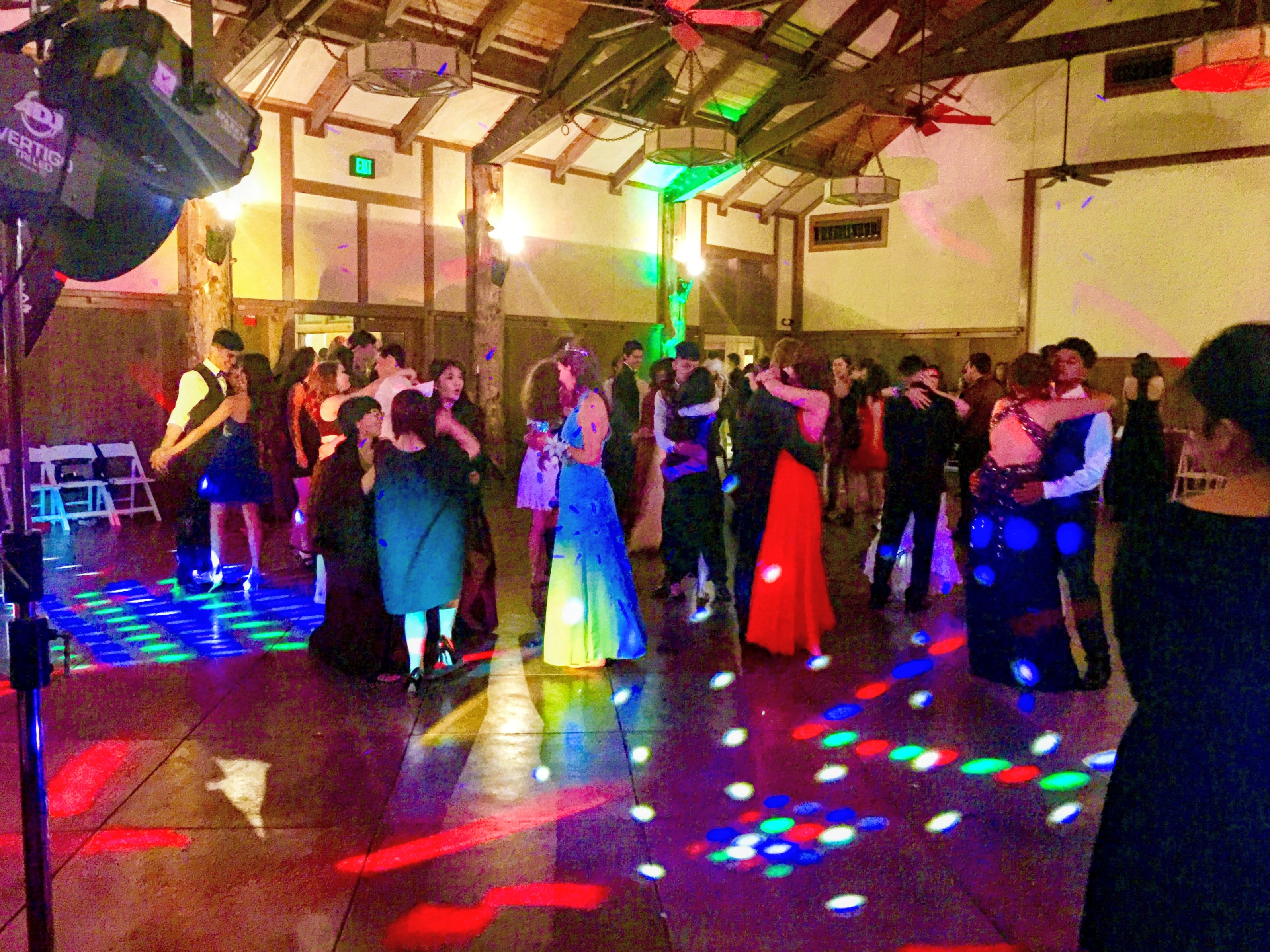 High school dance floor under colored lights
